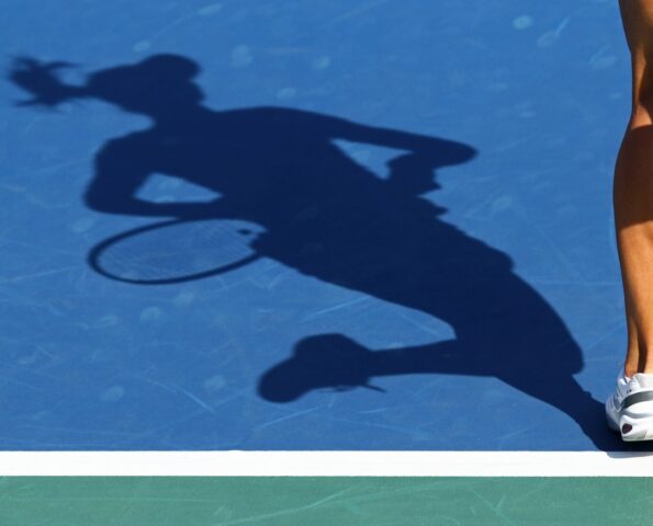 Shadow of woman tennis player, serving the ball